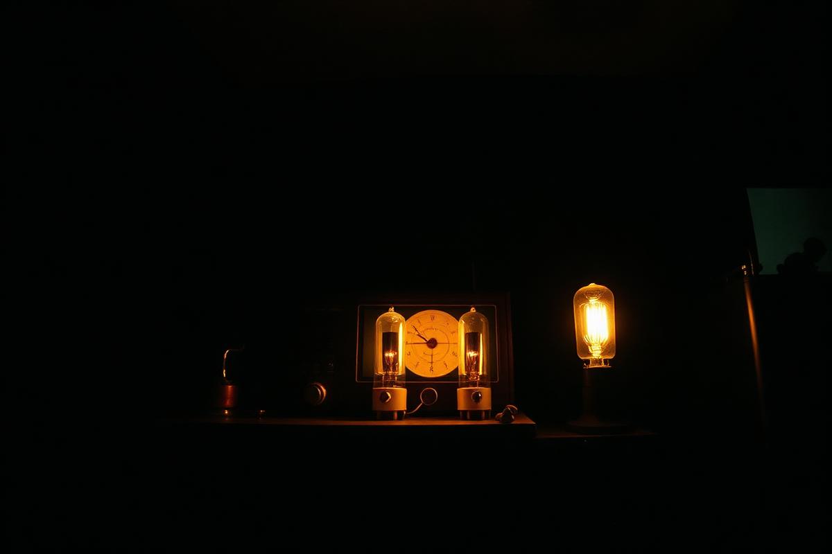 Vintage radio transmitter valves glowing in a dark room